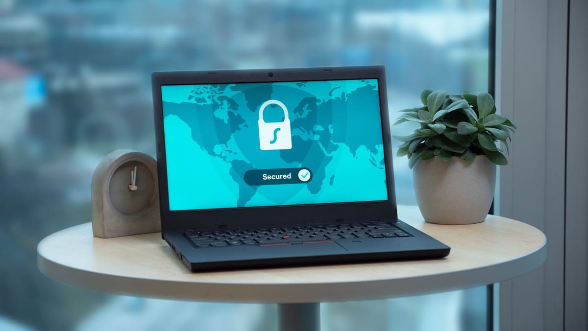 Laptop on a small table displaying a padlock icon and a Secured message