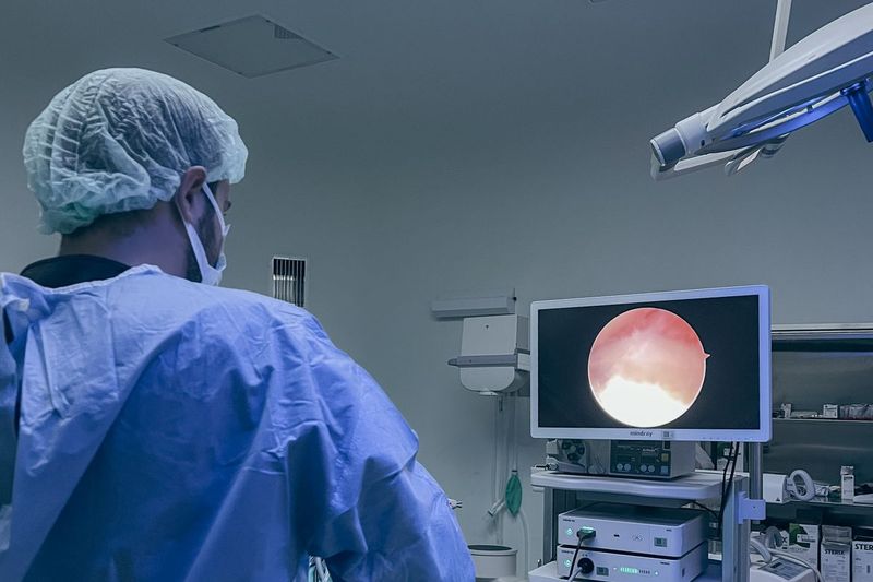 Clinician monitoring real-time patient data on screens during a procedure