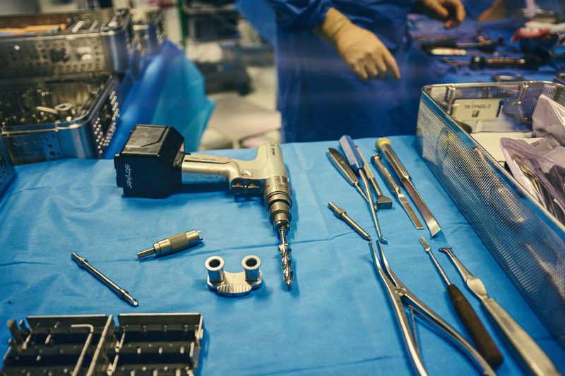 Surgical implants, screws and instruments laid out on a sterile tray before a procedure