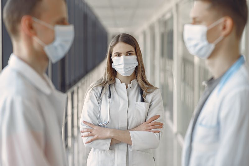 Medical team collaborating in hospital corridor on patient care quality