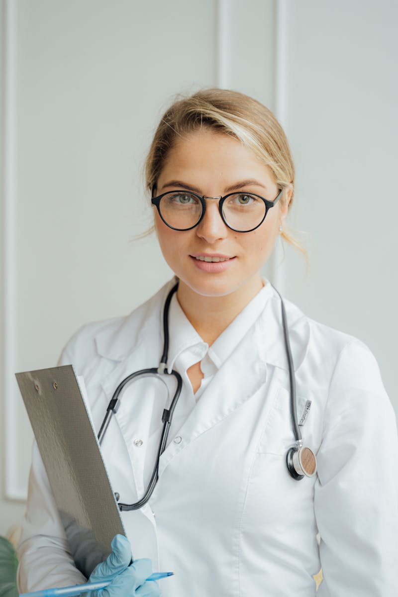 Physician with clipboard and stethoscope documenting patient encounter for charge capture