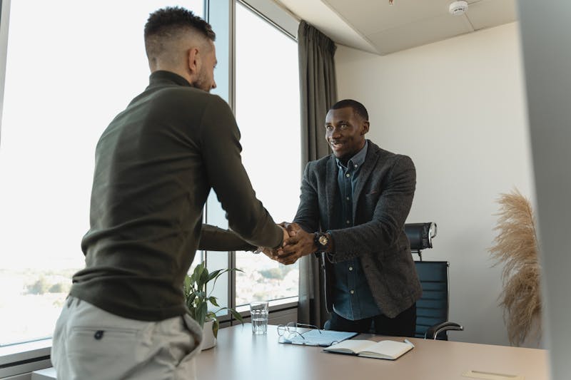 Job interview handshake representing healthcare recruitment and hiring