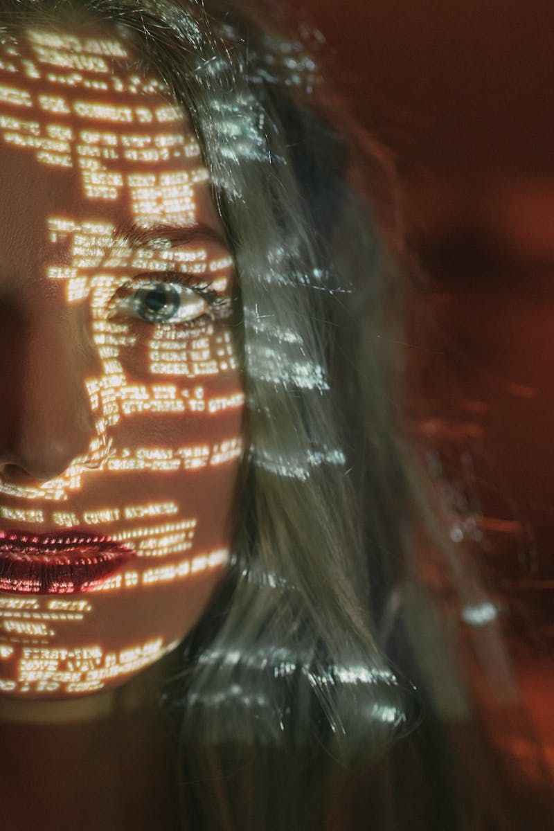 Lines of code projected across a person's face
