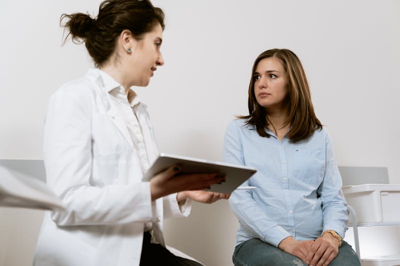 OB/GYN physician consulting with female patient during office visit