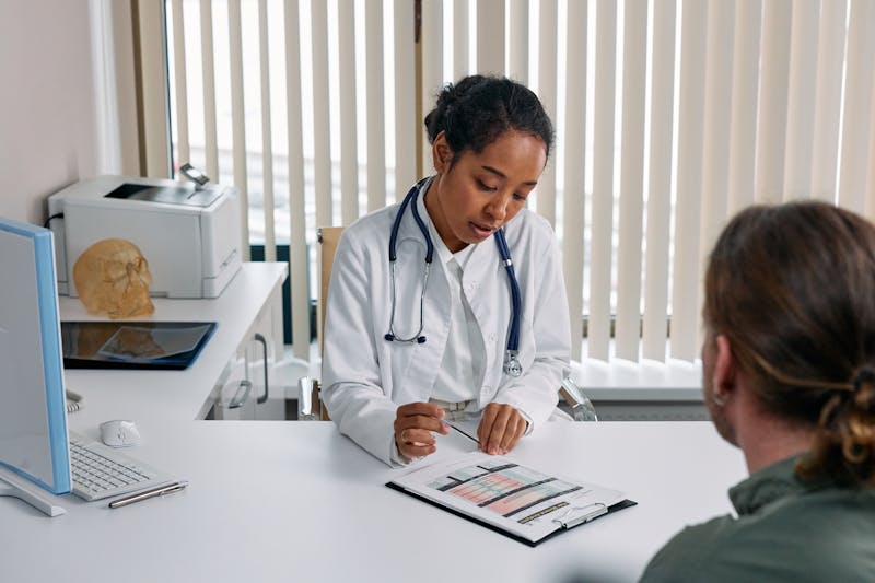 Doctor reviewing billing charts and patient records during consultation