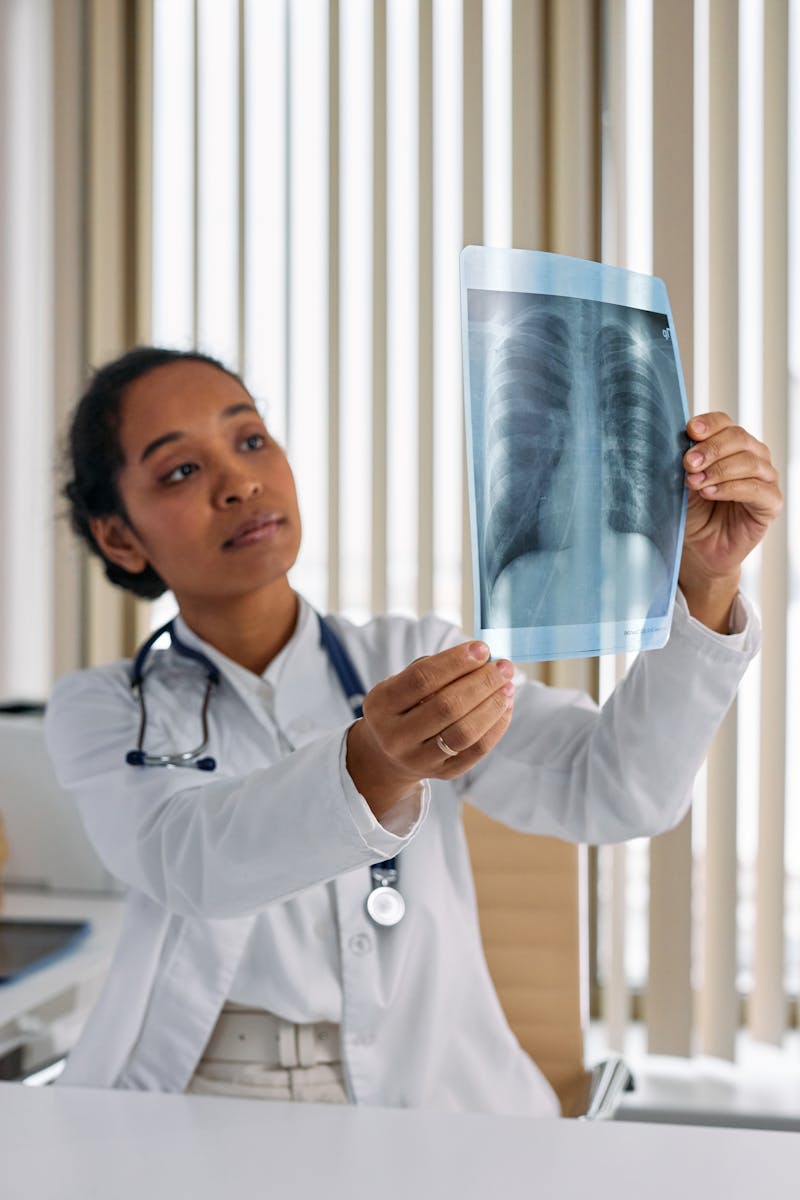 Physician examining diagnostic images as part of medical documentation