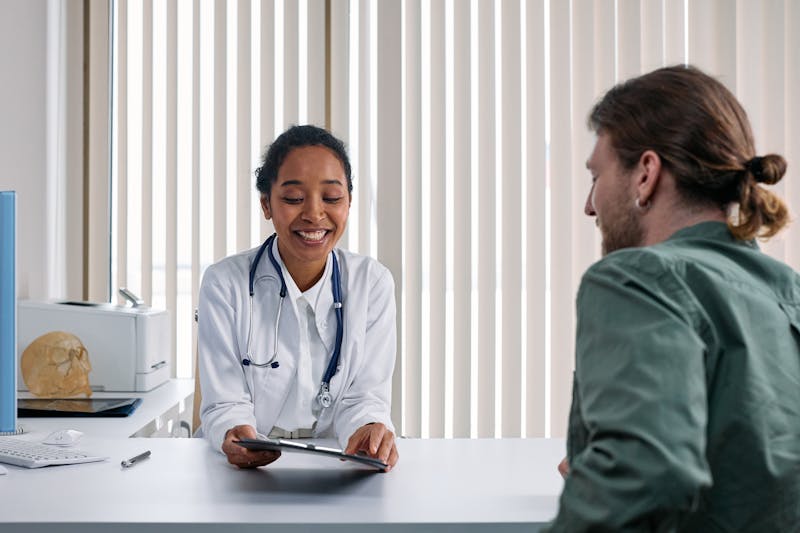 Primary care physician consulting with patient during office visit