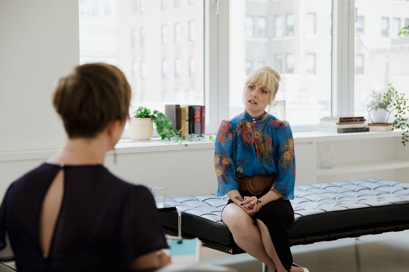 Therapist and client during an individual psychotherapy session in a bright office