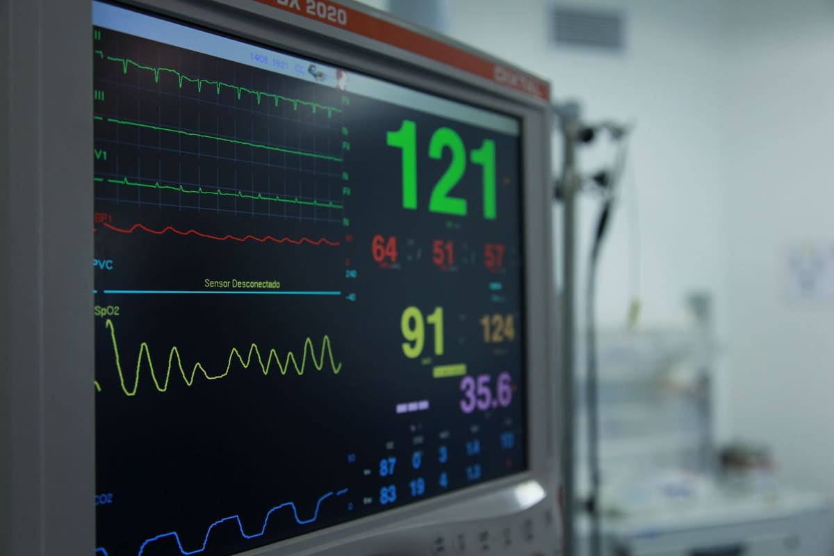 Patient monitor showing heart rate, blood pressure and oxygen saturation readings